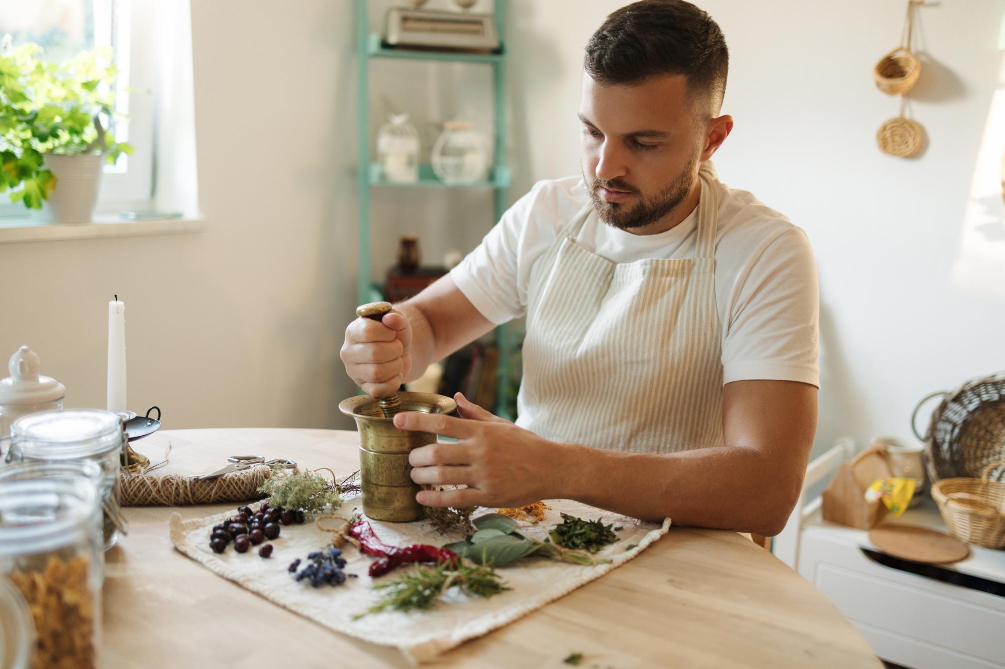 Founder in a small kitchen arranging herbs