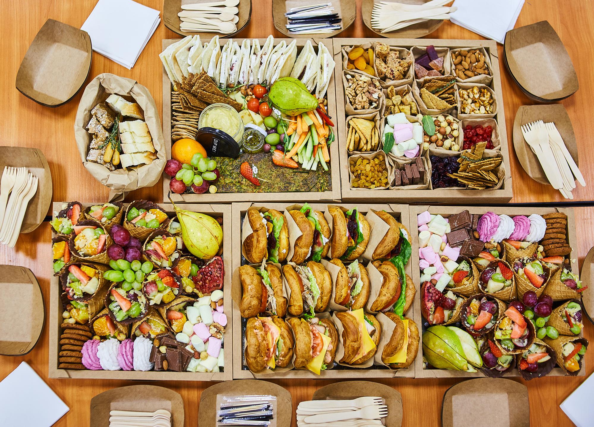 Assorted catering packages displayed on table